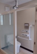 A photo of the transparent toilet cubicle when the door is unlocked.